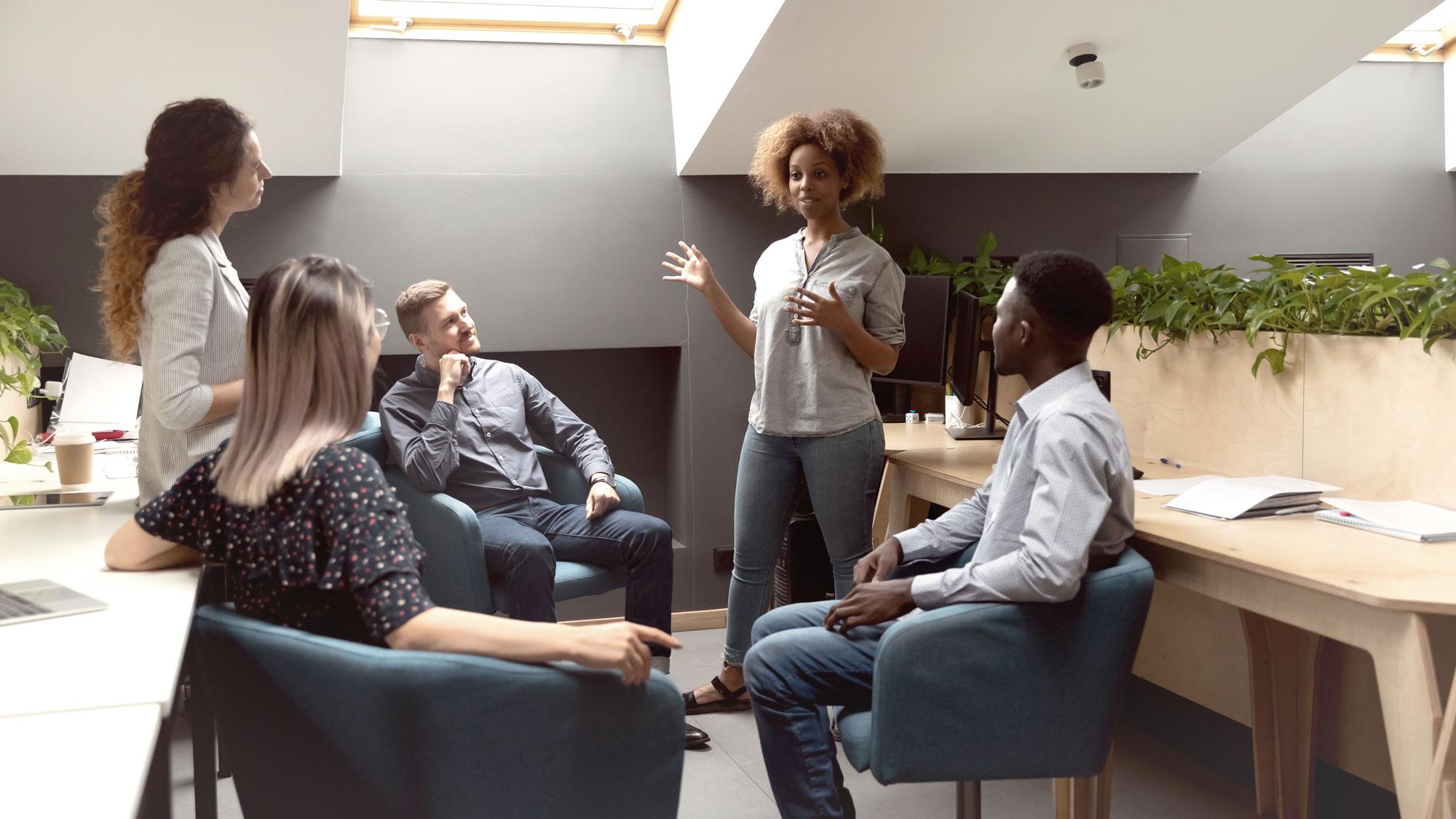 African American female mentor talking to multiethnic group